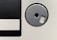 A close-up of a vintage floppy disk, showcasing the circular metal shutter and a portion of the black magnetic disk area.