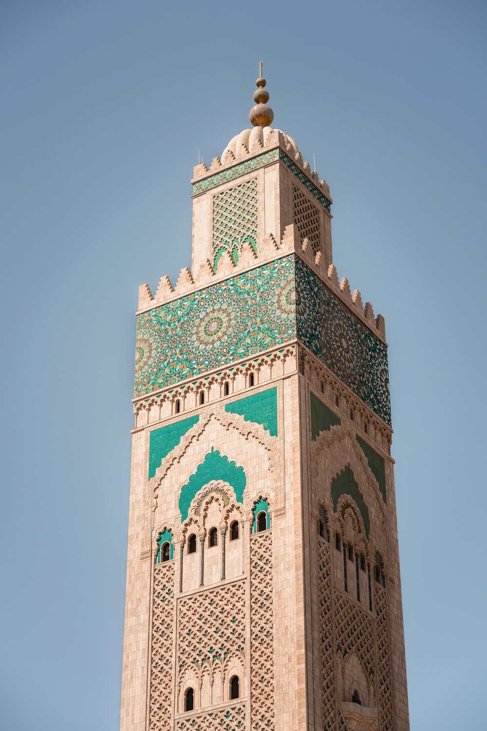 a tall tower with a green and white design on it