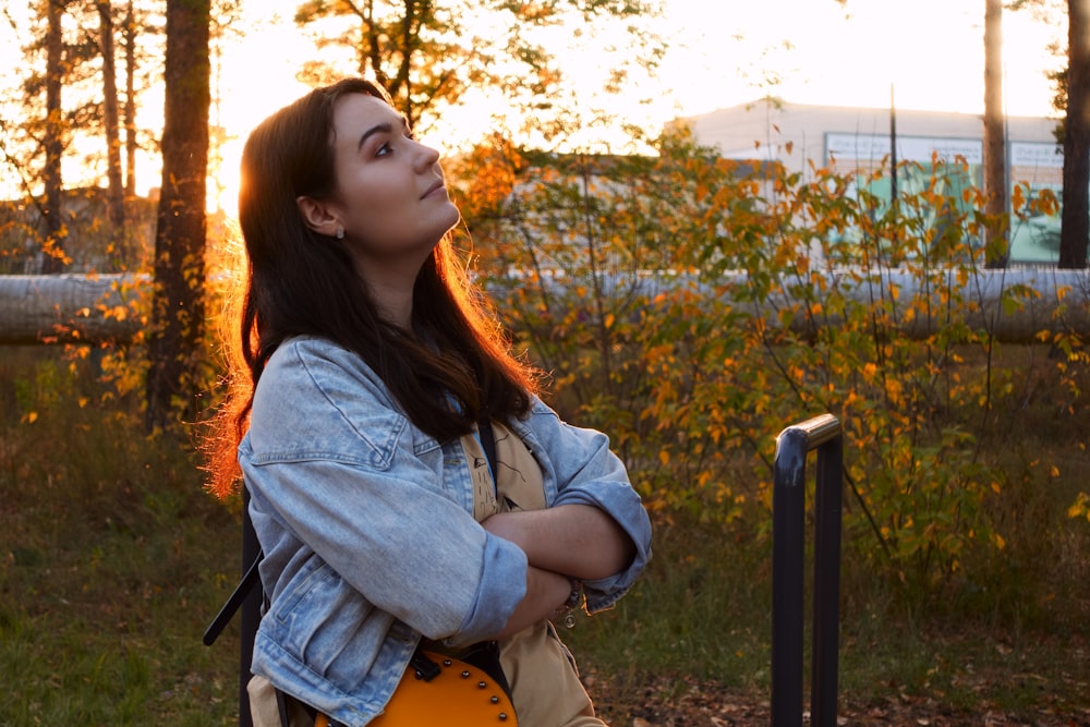 a woman with a yellow guitar standing in a field