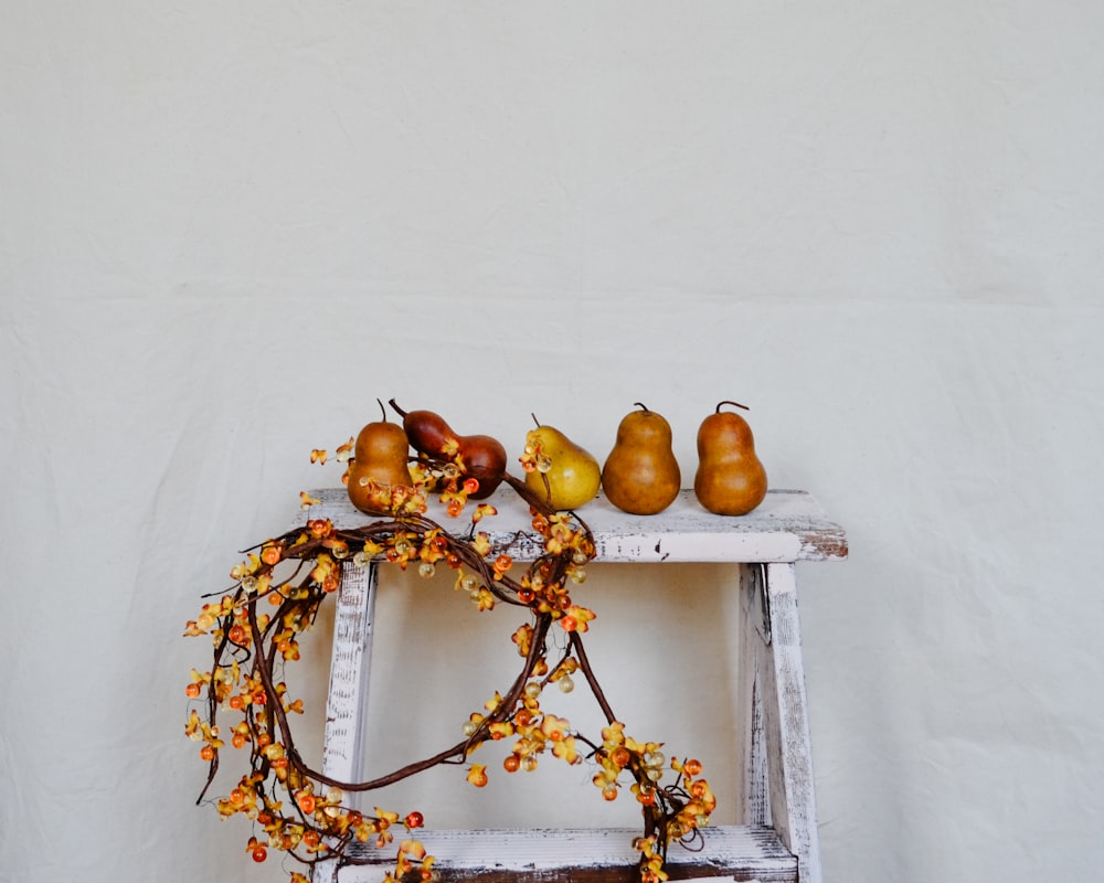 a ladder with a bunch of fruit on top of it