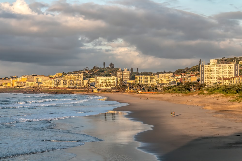 a beach with a city in the background