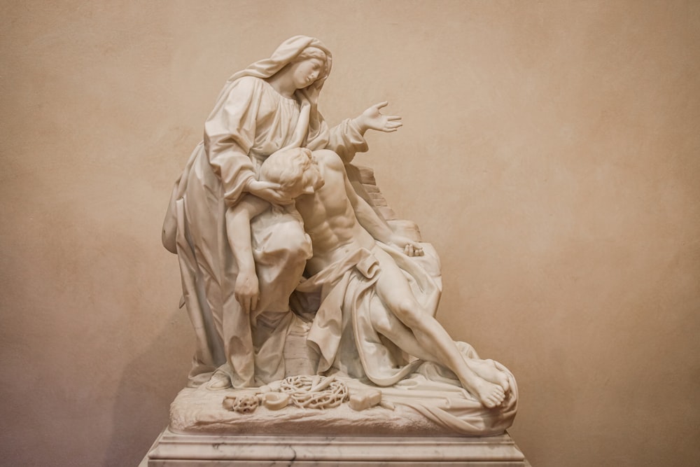 a statue of a man holding a woman