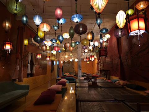 A bright, colorful room filled with cushions and warm lighting, inviting individuals to relax and connect.