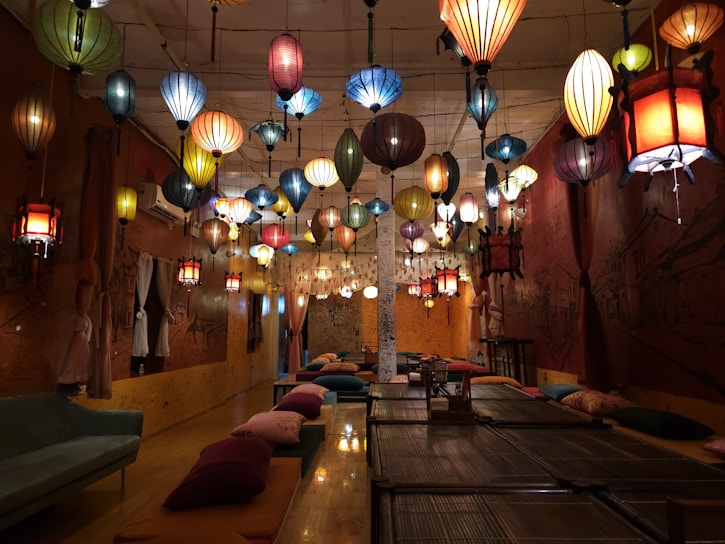 A warm, sunlit room filled with handcrafted dorram lanterns casting intricate shadows on the walls.