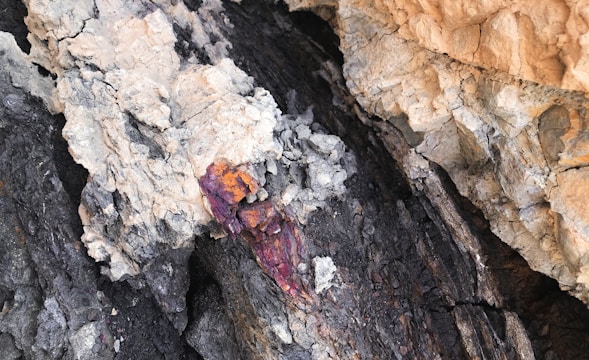 Geological cross-section showing stratified mafic-ultramafic layers with mineral deposits