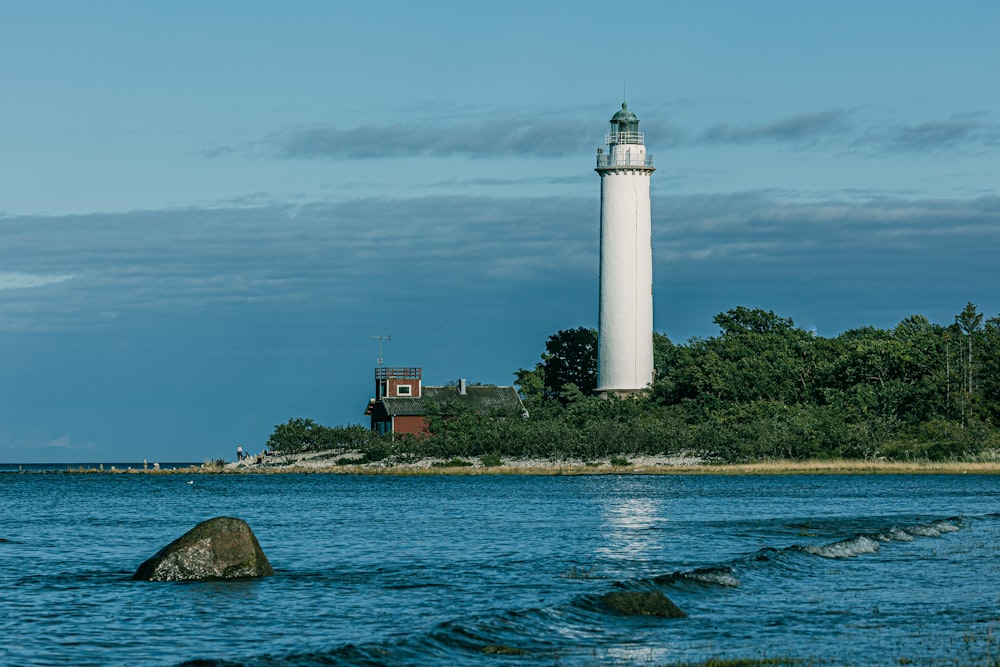 a light house sitting on top of a small island