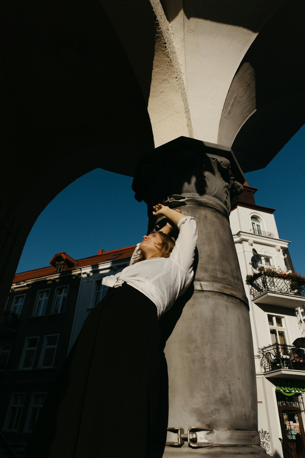 a man standing next to a tall statue