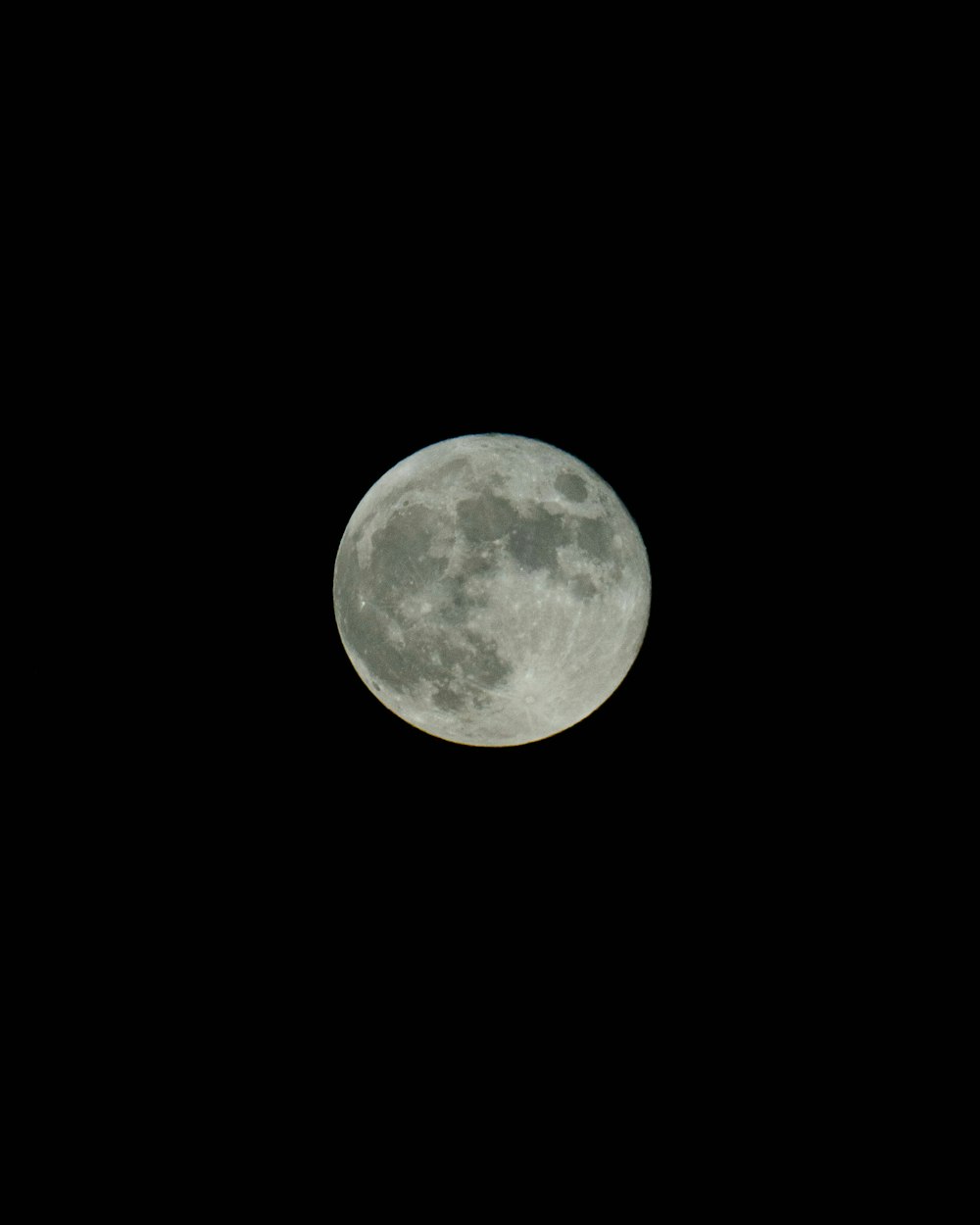 a plane flying in the sky with a full moon in the background