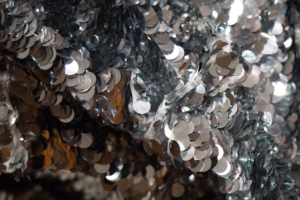 a pile of silver sequins sitting on top of a table
