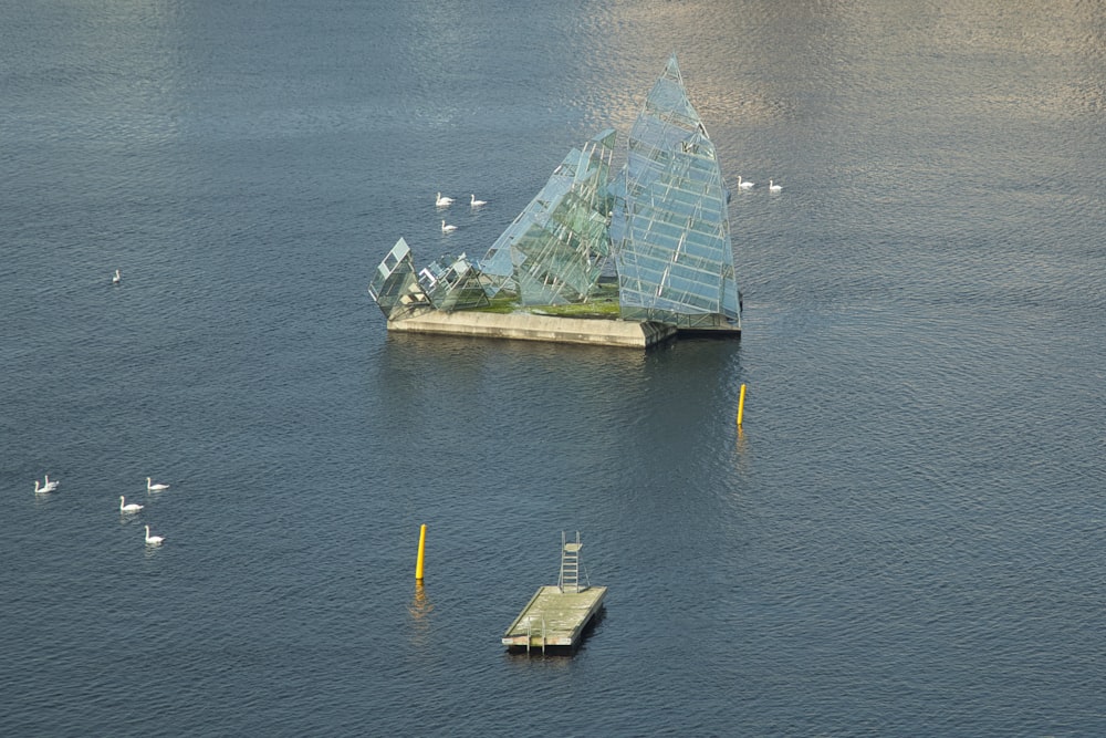 a pyramid shaped building sitting in the middle of a body of water