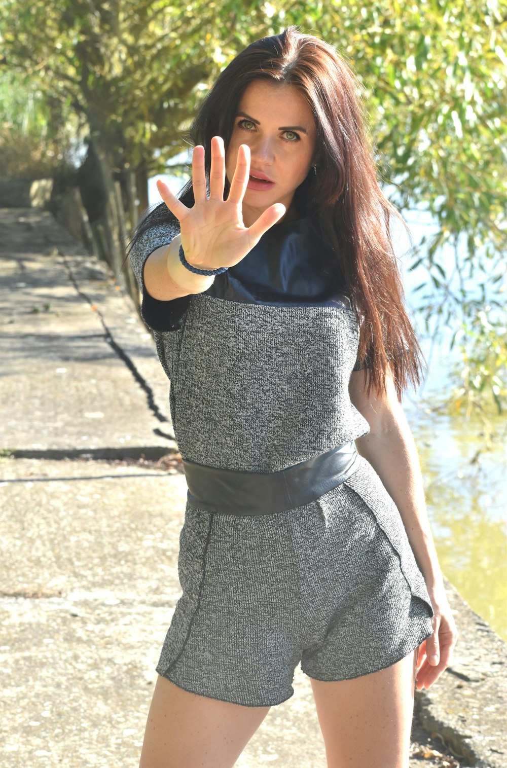 a woman with long hair wearing a gray outfit