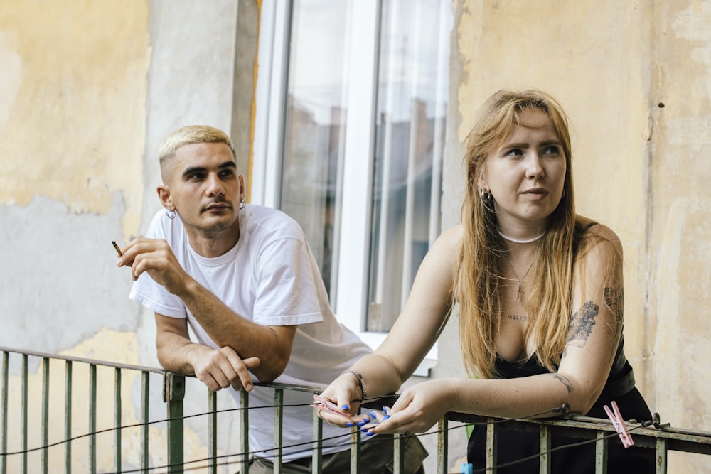 a man and a woman sitting on a balcony