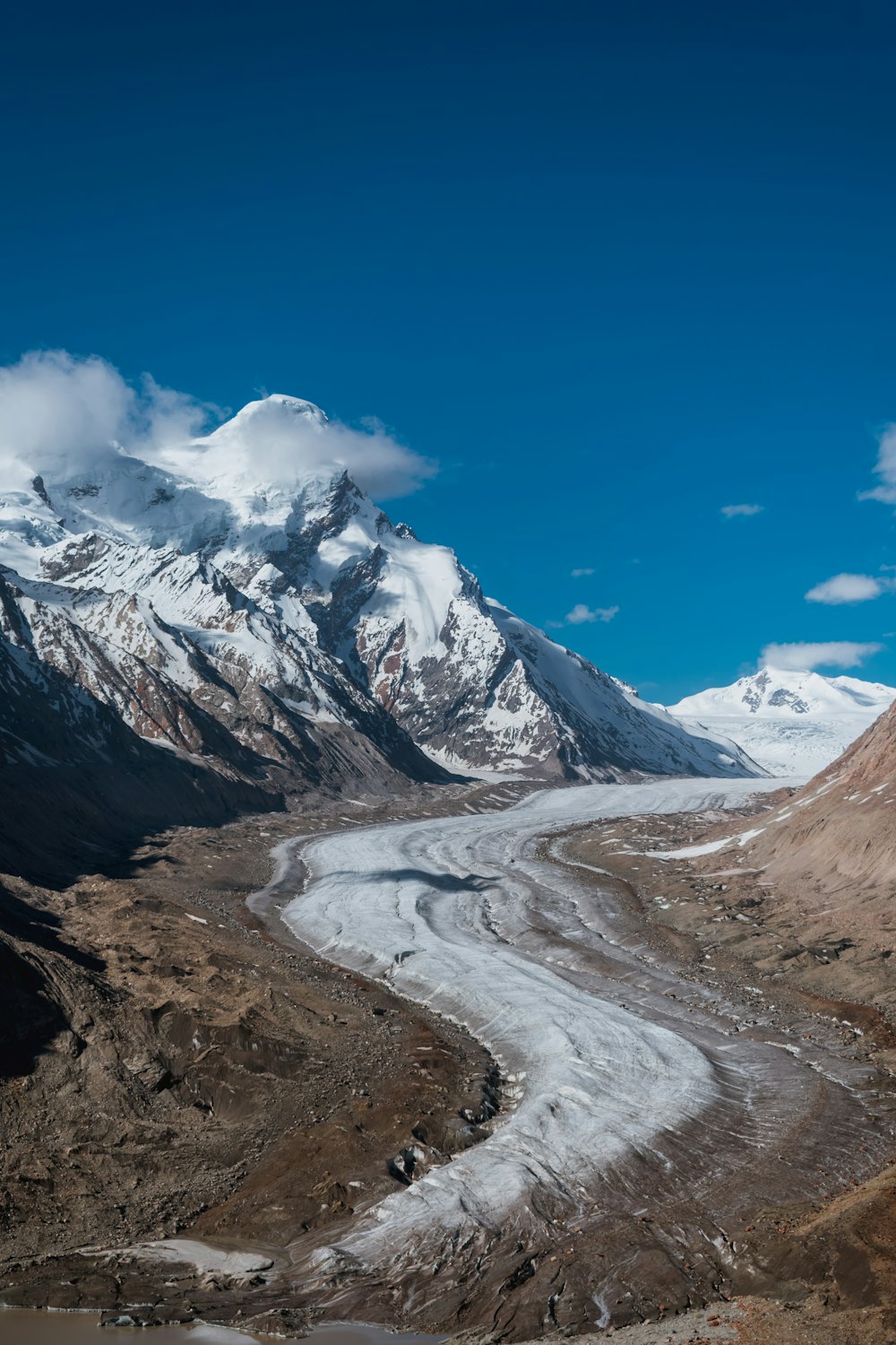 a view of a mountain range with a glacier in the foreground