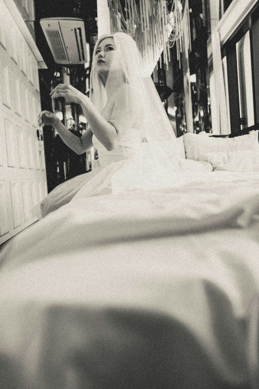 a black and white photo of a woman in a wedding dress