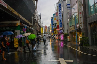 A vibrant street scene with people reacting differently to a sudden rainstorm.