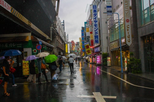A vibrant street scene with people reacting differently to a sudden rainstorm.