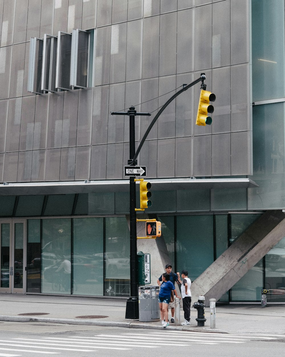 a group of people standing under a traffic light