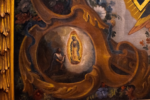 A detailed painting depicts a religious scene with a central figure illuminated by an intricate golden frame. Surrounding the figure are rich floral decorations and swirling ornate patterns in warm tones. The artwork conveys a sense of devotion and reverence.