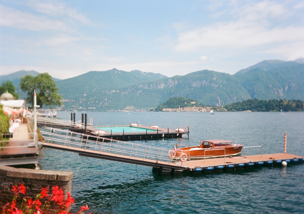 a boat is docked at a pier on a lake