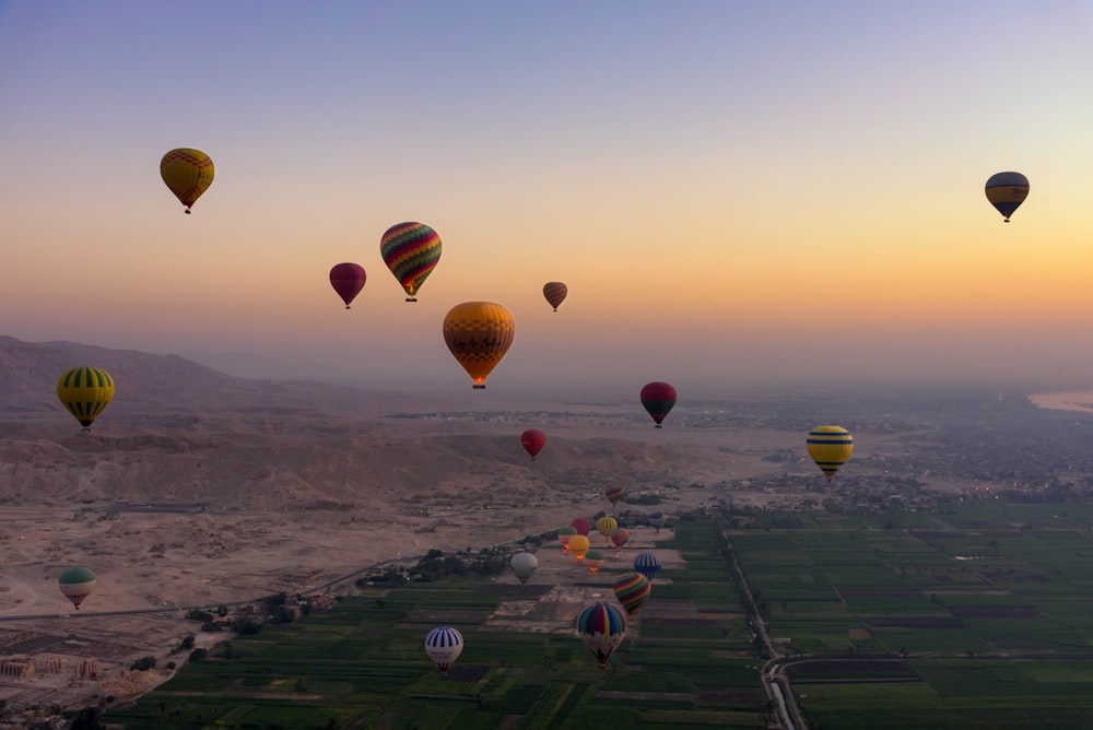 a bunch of hot air balloons flying in the sky