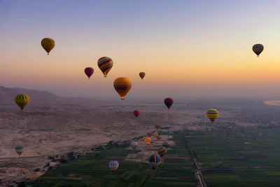 Balloons filling the dawn sky over Luxor