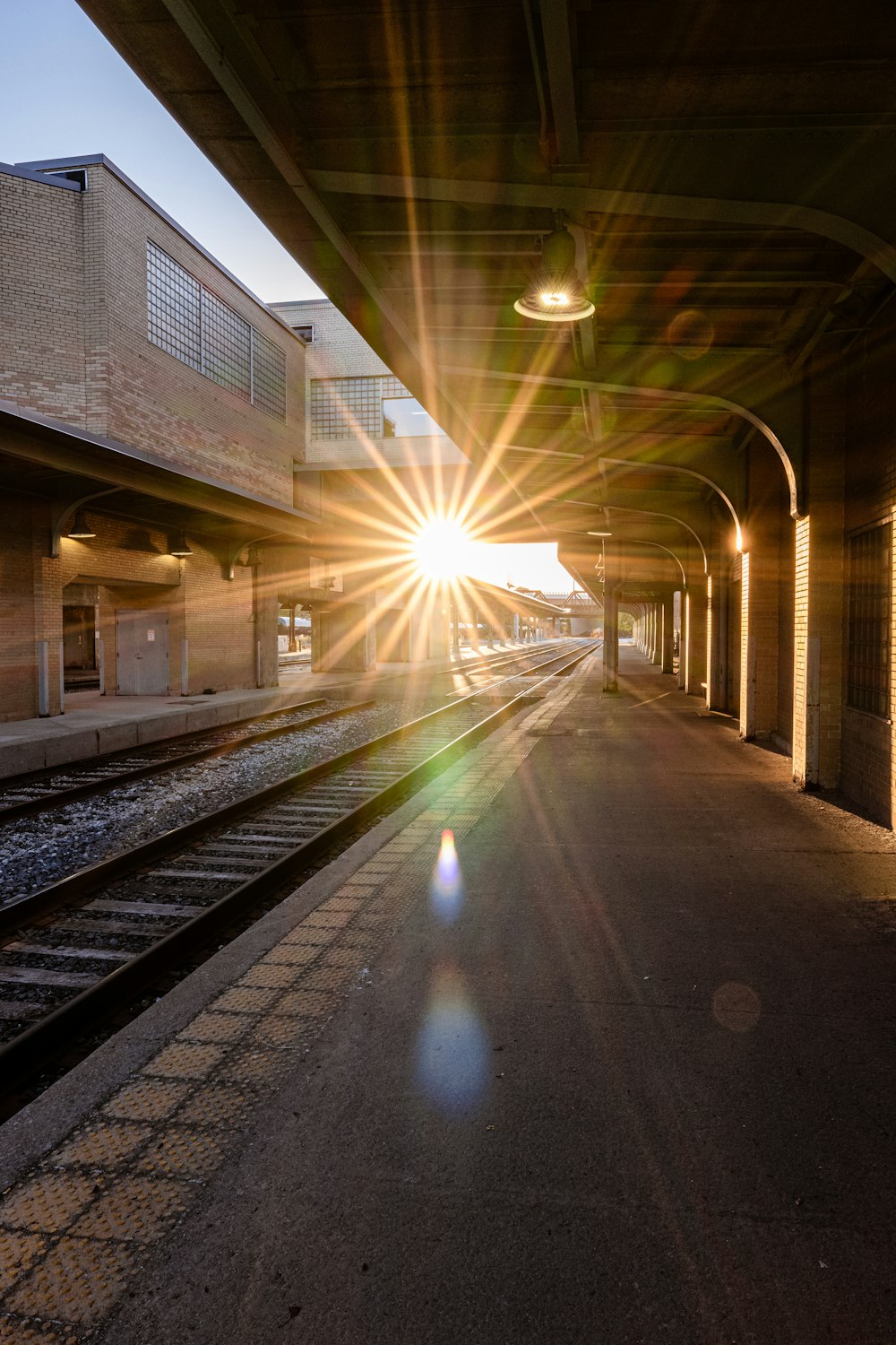 a train station with a train on the tracks