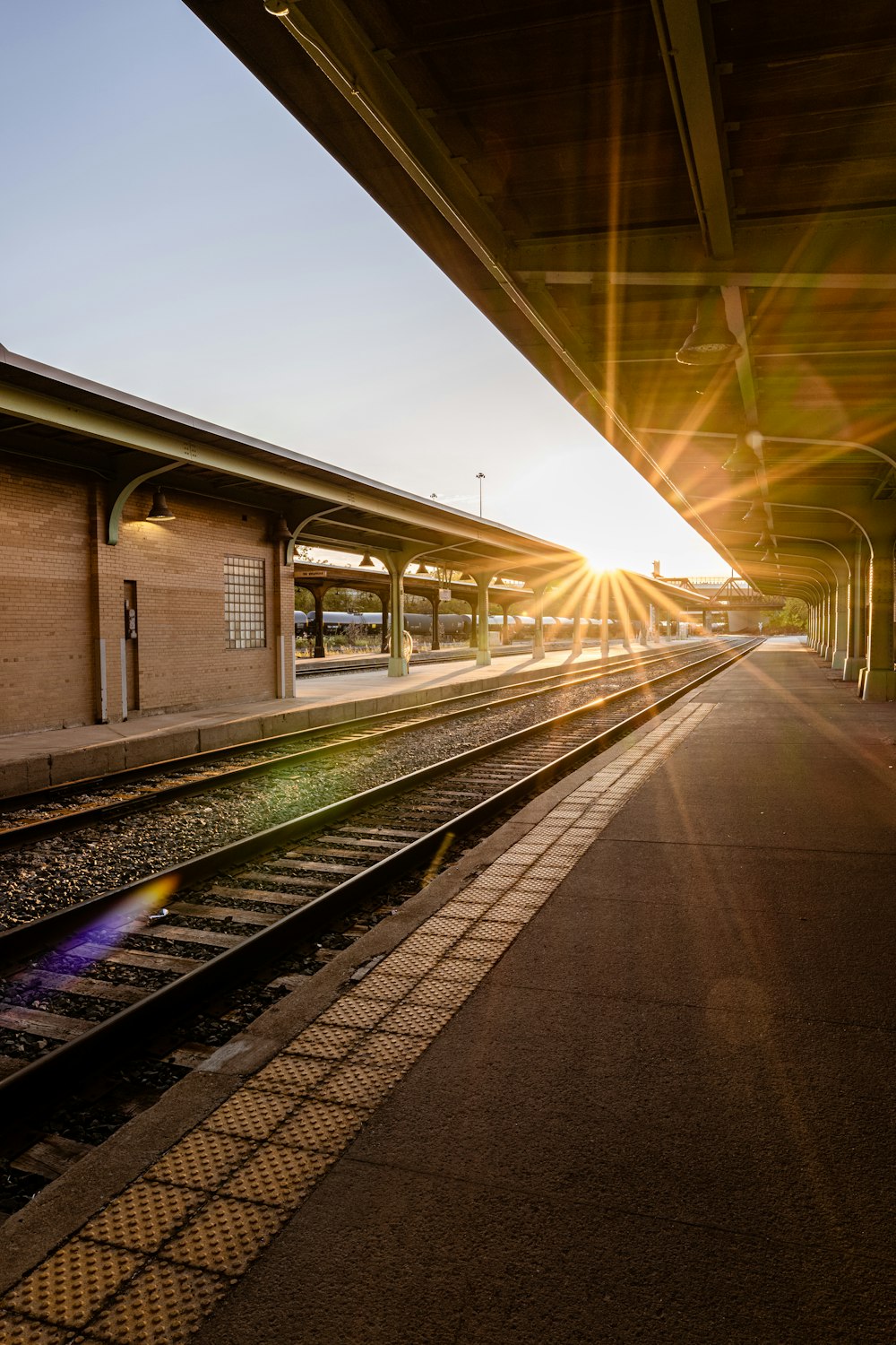 a train station with a train on the tracks