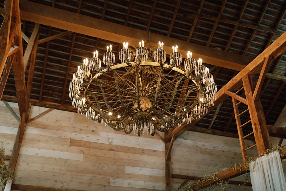 a chandelier hanging from the ceiling of a barn