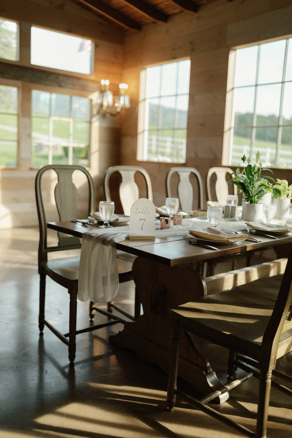 a dining room table set with place settings