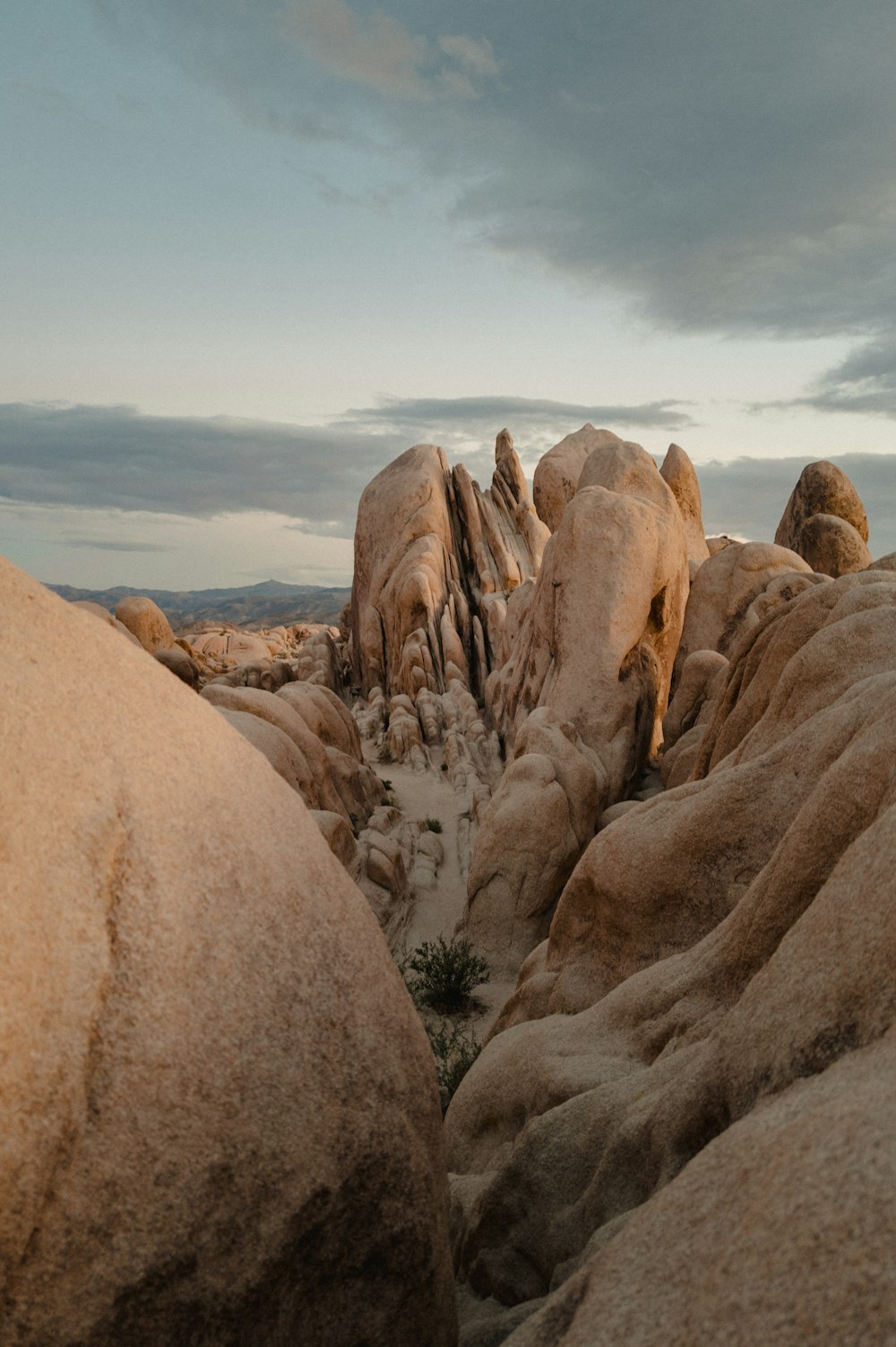 a large rock formation with a sky in the background