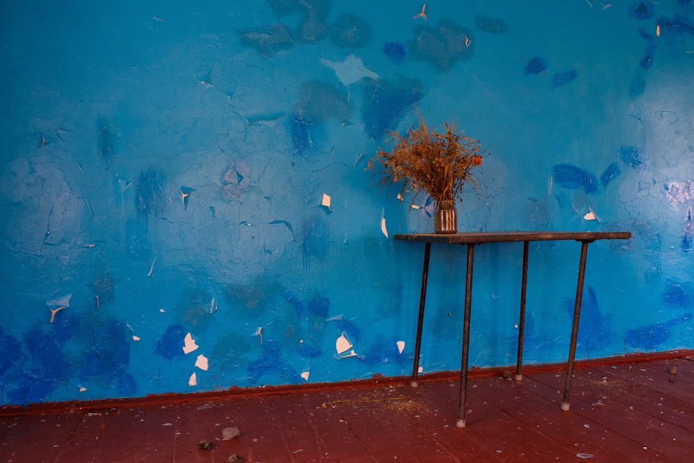 a table with a vase of flowers on top of it