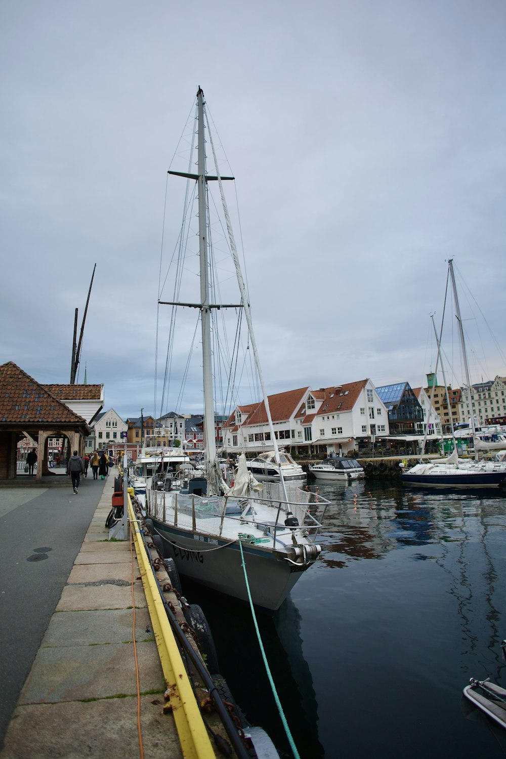 a sailboat docked at a dock in a harbor