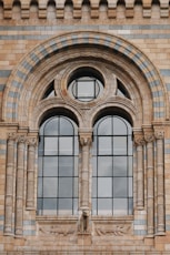 a large brick building with two arched windows