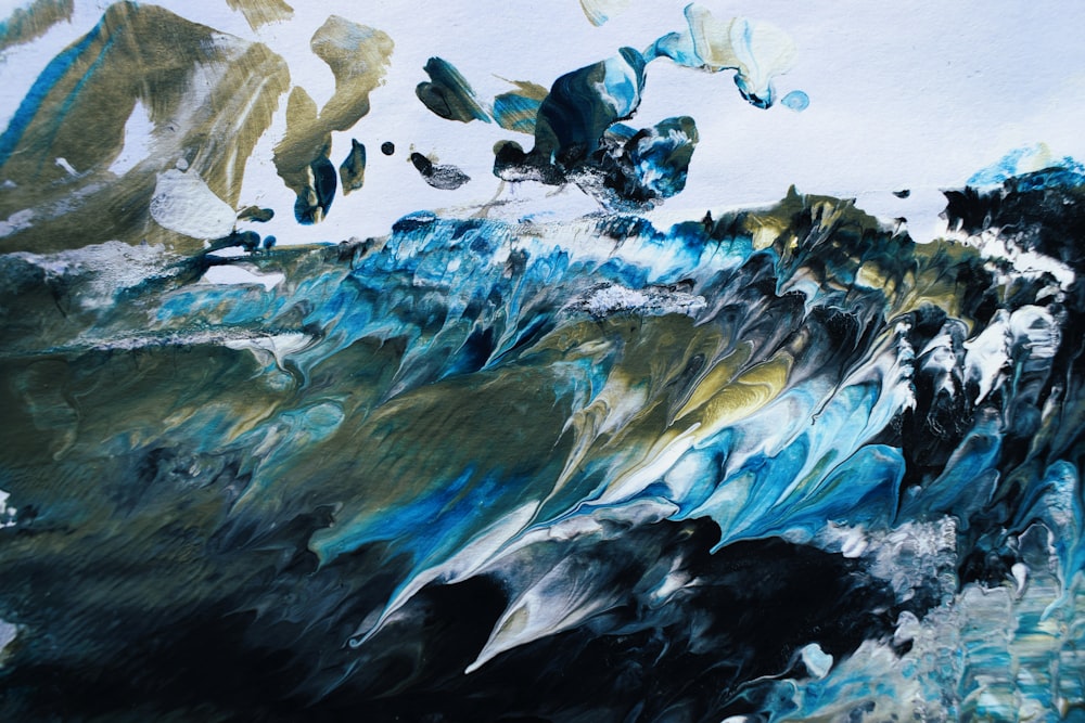 a painting of a wave with blue and gold colors