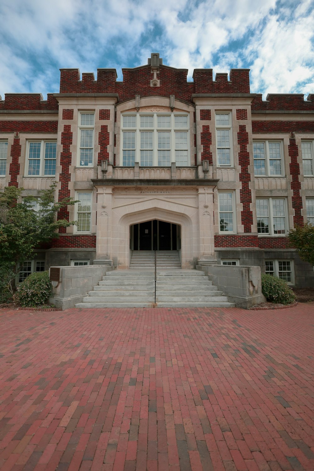a large brick building with stairs leading to it