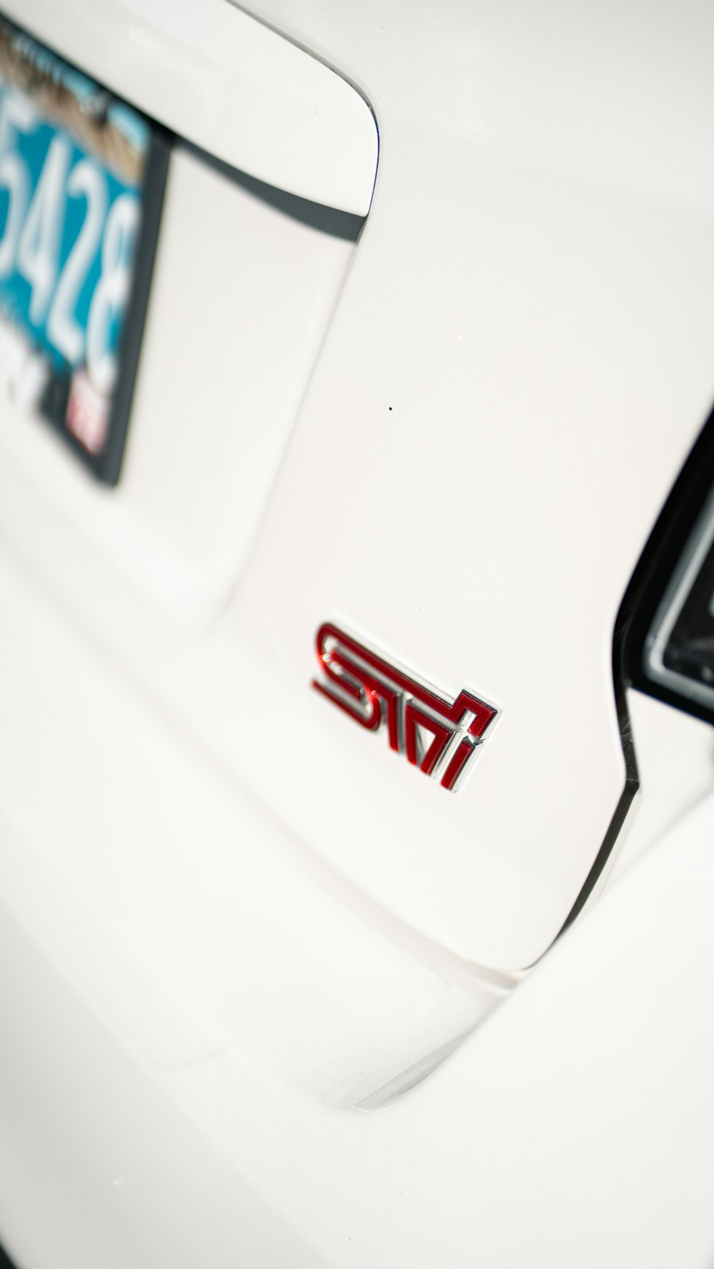 a close up of the emblem on a white car