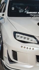 Close-up of a custom car body kit being installed, highlighting sleek lines and craftsmanship.