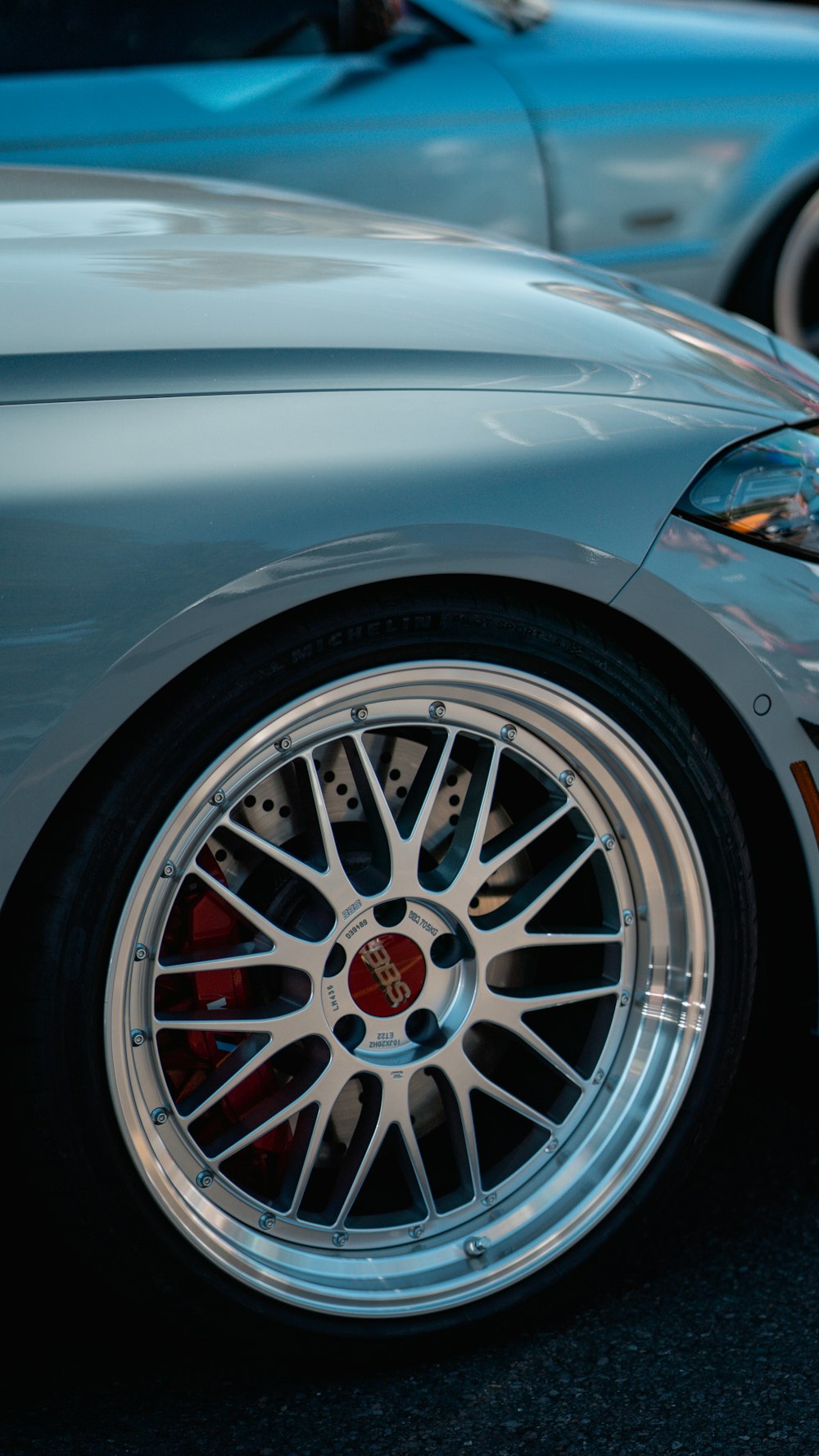 a close up of a car's wheels on a street