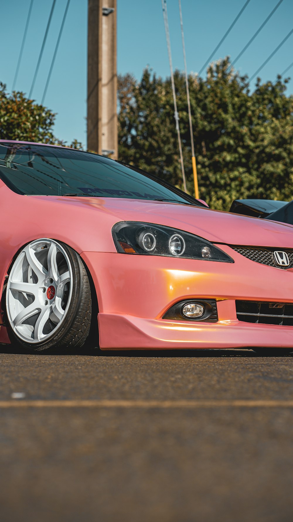 a pink car parked in a parking lot