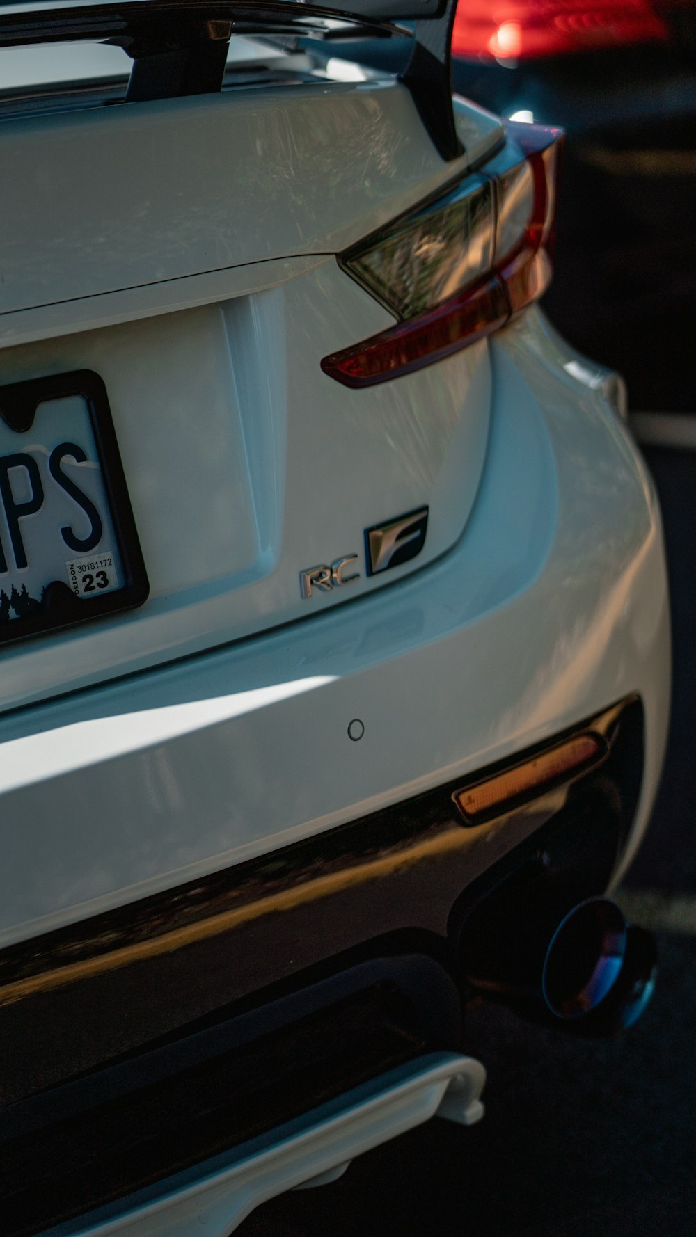 a close up of a white car with a license plate