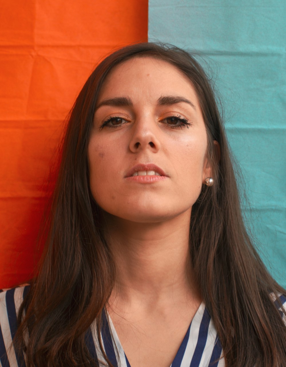 a woman with long hair and a striped shirt