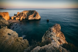 a body of water near a rocky shore