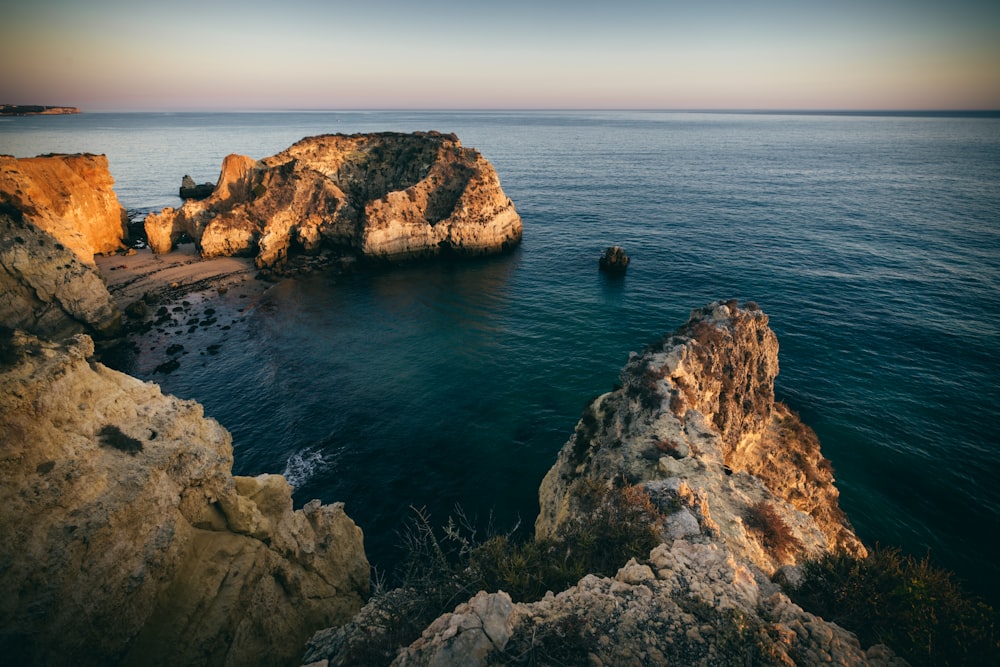 a body of water near a rocky shore