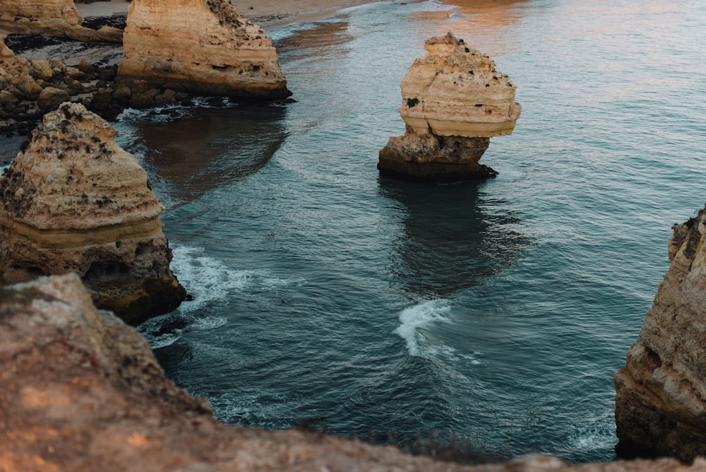 a body of water surrounded by large rocks