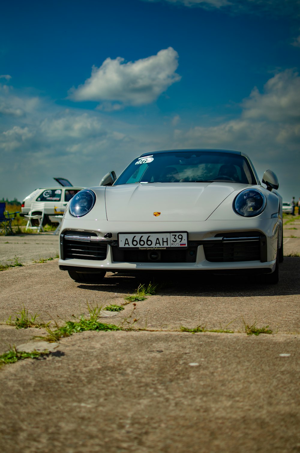 a white sports car parked in a parking lot