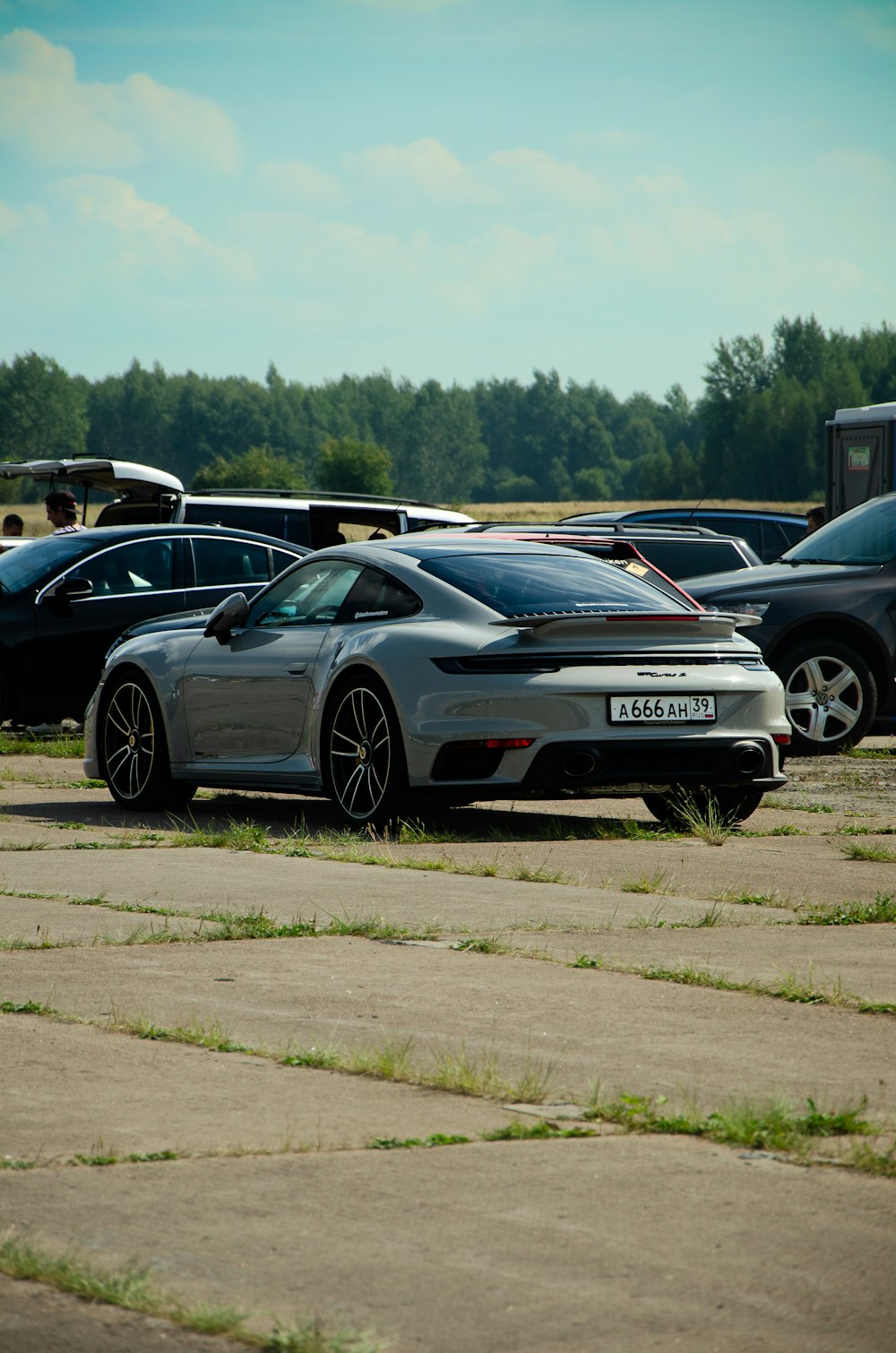 a grey sports car parked in a parking lot
