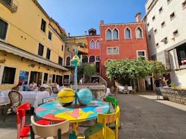 An elegant outdoor restaurant scene featuring colorful, durable chairs and tables.