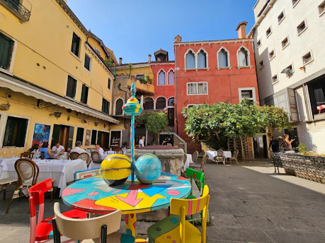 An elegant outdoor restaurant scene featuring colorful, durable chairs and tables.