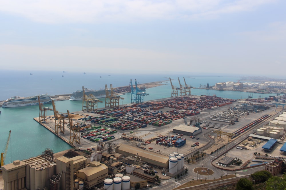 a harbor filled with lots of ships next to a large body of water