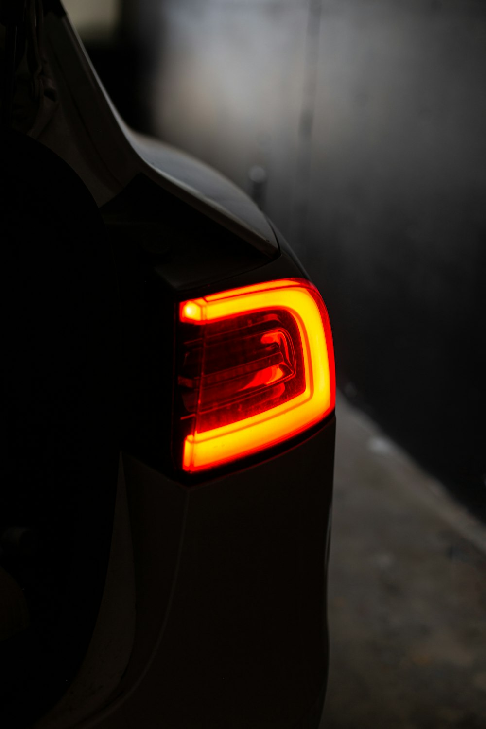 the tail light of a car in the dark